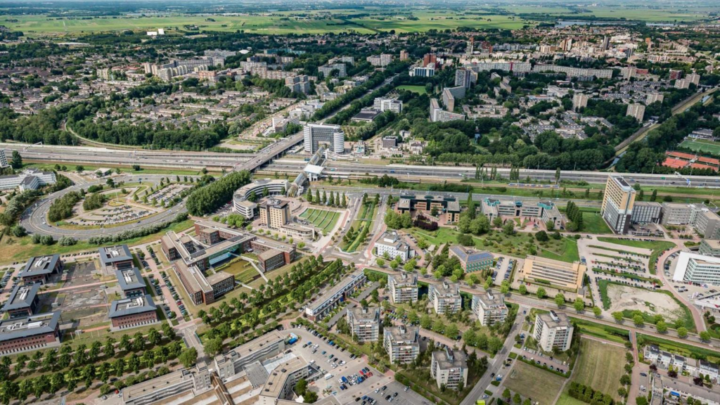 An aerial view of Zoetermeer showing the city skyline and modern urban layout.