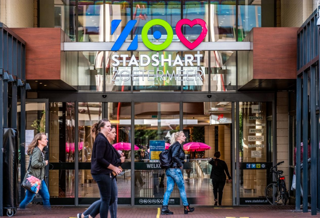 Tourists visiting Stadshart shopping center in Zoetermeer with surrounding modern buildings.