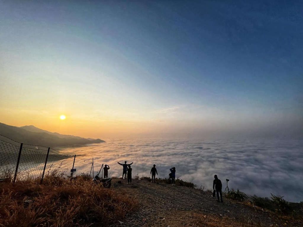 Visitors enjoying panoramic views of hills and sunrise at Bhedetar near Dharan, Nepal.