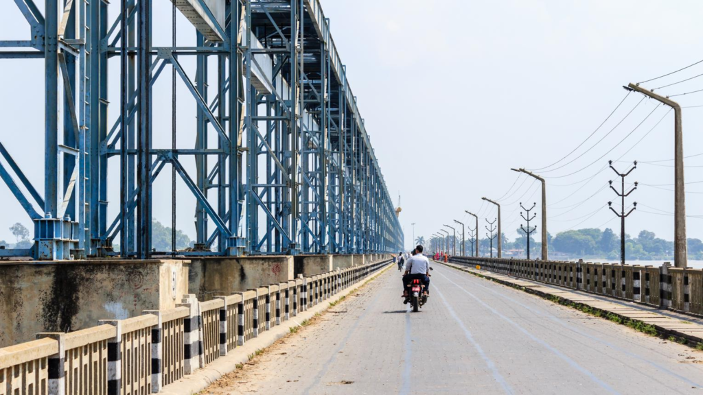Visitors viewing the Koshi Barrage near Biratnagar, Nepal, with river and surrounding landscape.