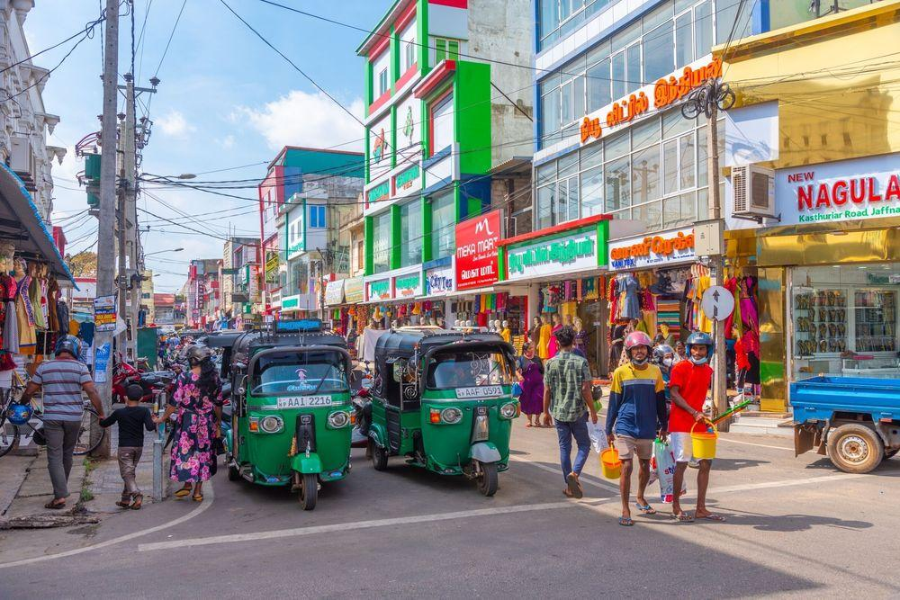 Visitors walking through streets in Jaffna with local markets, shops, and pedestrian activity.