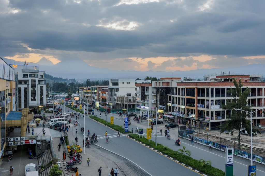 Visitors walking through streets in Musanze with local markets, shops, and pedestrian activity.