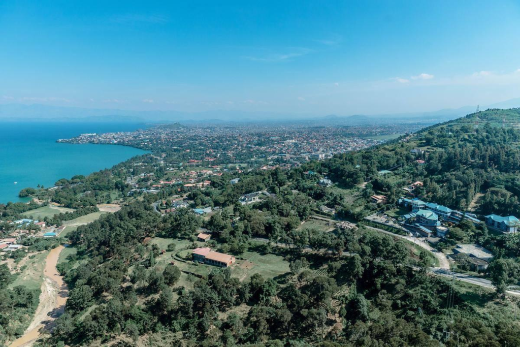 A panoramic aerial view of Gisenyi showing the cityscape along Lake Kivu with surrounding hills in Rubavu District, Rwanda.