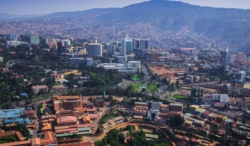 A panoramic aerial view of Kigali showing the cityscape, urban areas, and surrounding hills in Rwanda.