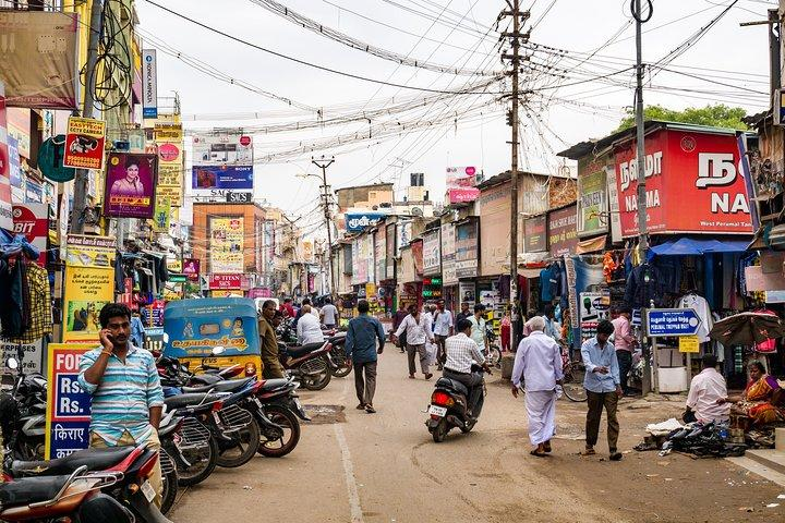 Bustling streets of Madurai with local shops and traffic
