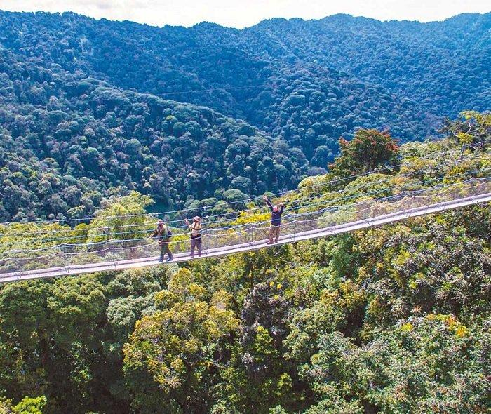 Visitors exploring natural landscapes near Muhanga, Rwanda, with green hills and countryside scenery.