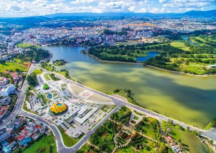 Xuan Huong Lake in Dalat, Vietnam with surrounding gardens and mountains.
