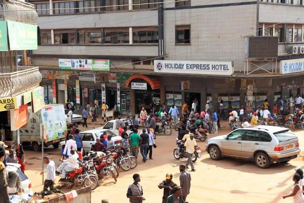 Visitors walking through streets in Mwanza with local markets, shops, and pedestrian activity.