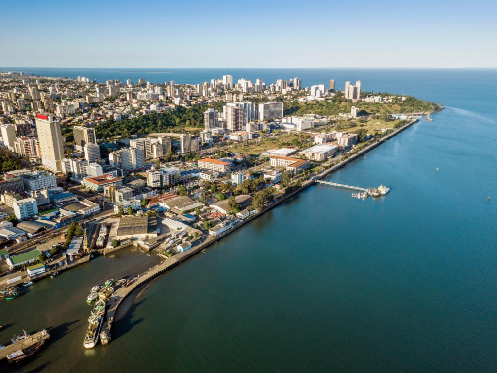 A panoramic aerial view of Maputo showing the cityscape, port, and coastline along the Indian Ocean in Mozambique.