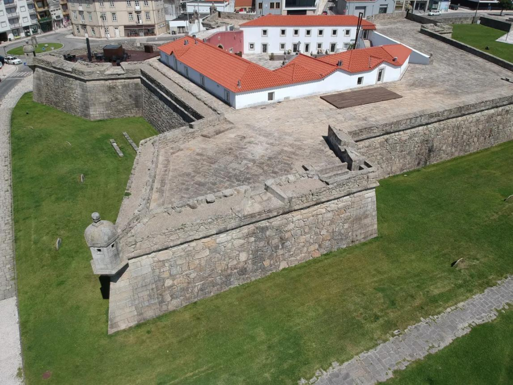 Visitors exploring Maputo Fortress in Mozambique, a historic landmark with colonial architecture.