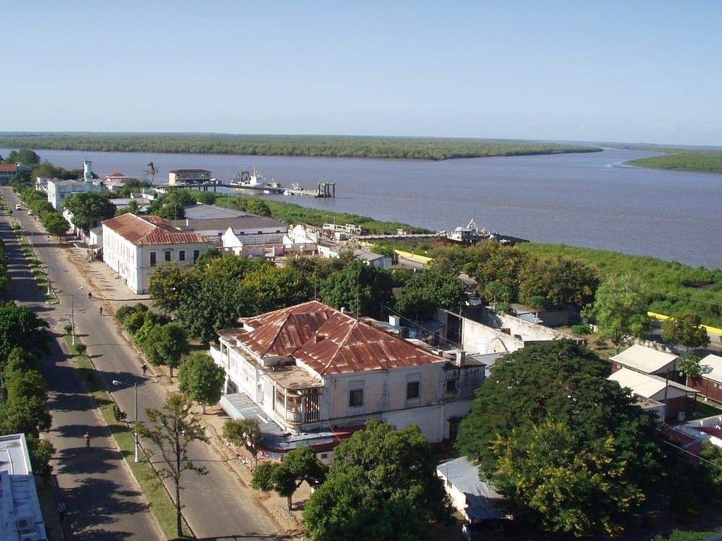 A panoramic aerial view of Quelimane showing the cityscape along the river and coastline in Zambezia Province, Mozambique.