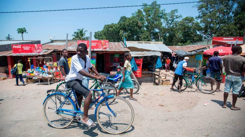 Visitors walking through streets in Quelimane with local markets, shops, and pedestrian activity.