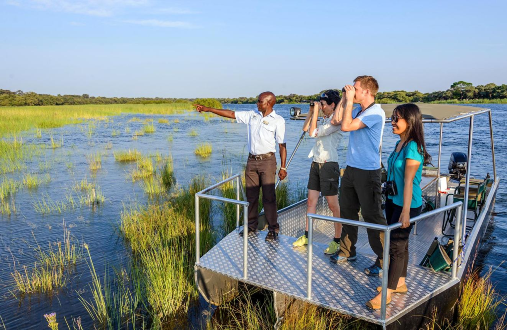 Visitors exploring the Kavango River near Rundu, Namibia, with boats and scenic river landscapes.