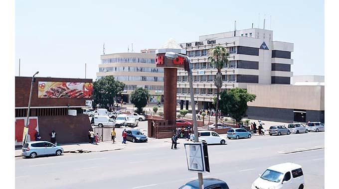 Visitors walking through streets in Kwekwe with local shops, markets, and pedestrian activity.