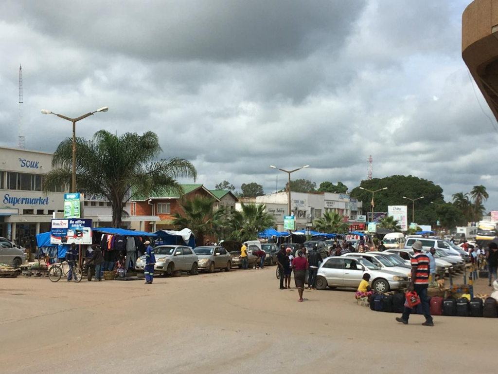 Visitors walking through streets in Kabwe with local markets, shops, and pedestrian activity.