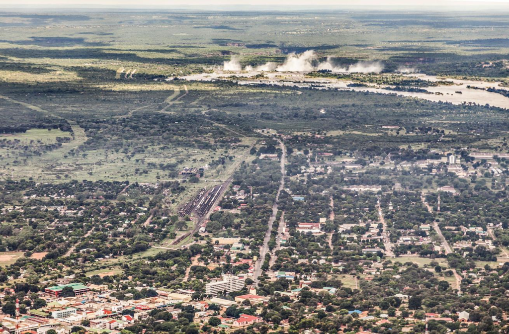 A panoramic aerial view of Livingstone showing the cityscape with the Zambezi River and surrounding area near Victoria Falls in Zambia.