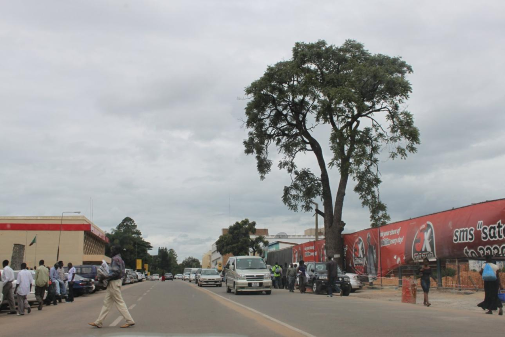 Visitors walking through streets in Kitwe with local shops, markets, and pedestrian activity.