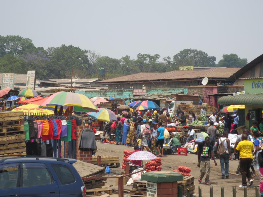 Visitors walking through streets in Ndola with local shops, markets, and pedestrian activity.