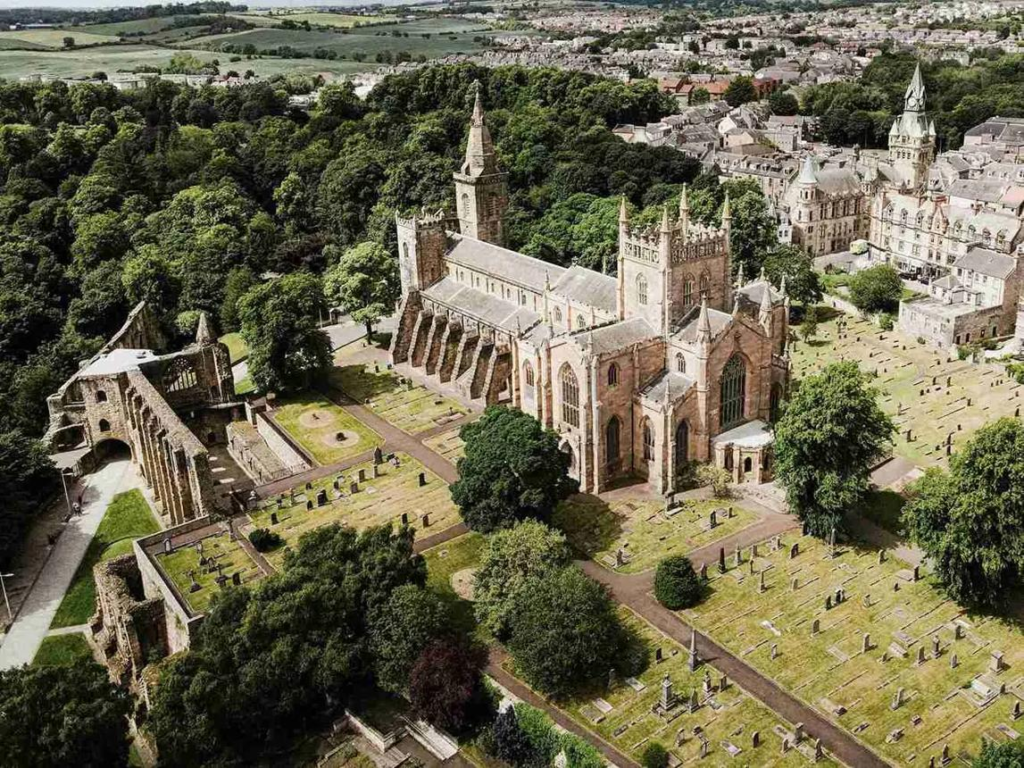 Visitors exploring Dunfermline Abbey in Scotland, a historic landmark with cultural significance.