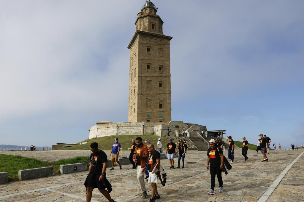 Visitors exploring the Tower of Hercules lighthouse in A Coruña, Spain, a historic maritime landmark.