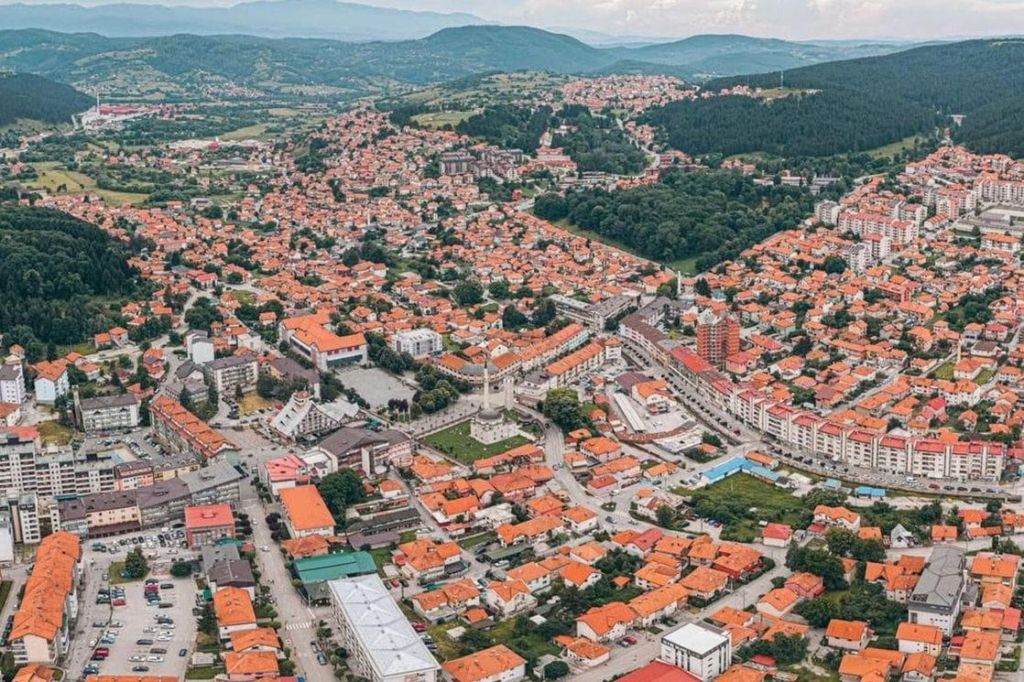 A panoramic aerial view of Pljevlja showing the cityscape, surrounding mountains, and rivers in Montenegro.