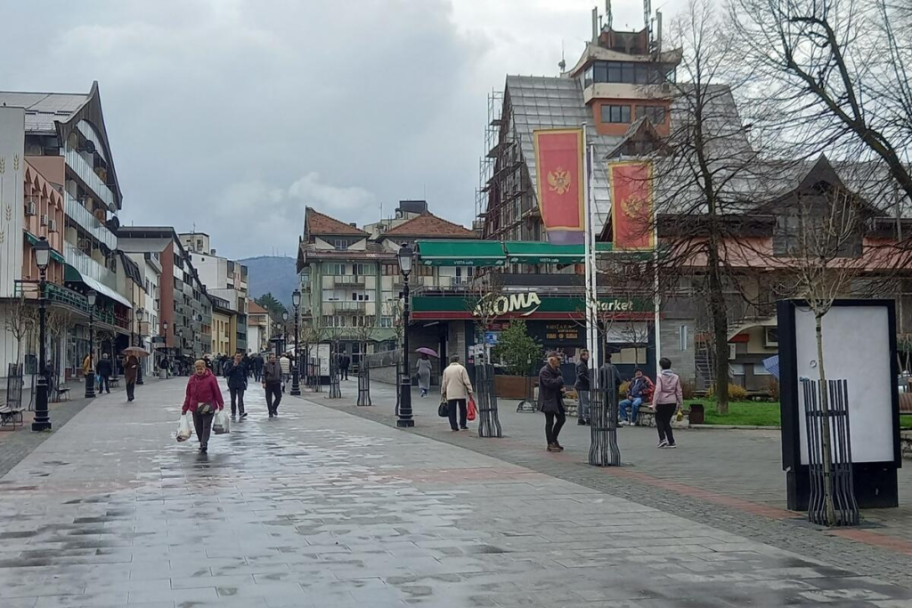 Visitors walking through streets in Pljevlja with local shops, cafés, and pedestrian activity.