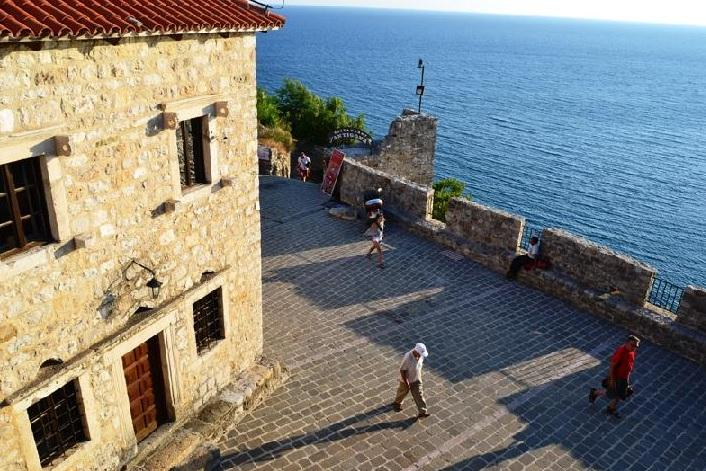 Visitors exploring Ulcinj Castle in Montenegro, a historic landmark overlooking the Adriatic Sea.