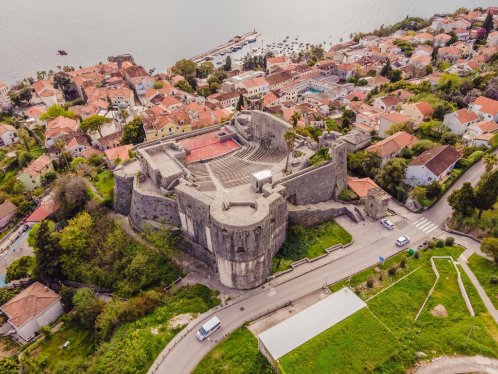 Visitors exploring Forte Mare in Herceg Novi, Montenegro, a historic fortress overlooking the Adriatic Sea.
