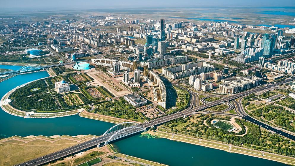 An aerial view of Astana showing the modern city skyline with futuristic architecture.