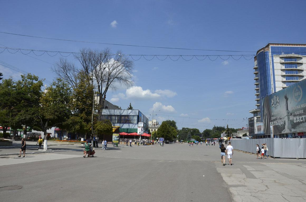Visitors walking through streets in Bălți with local shops, cafés, and pedestrian activity.