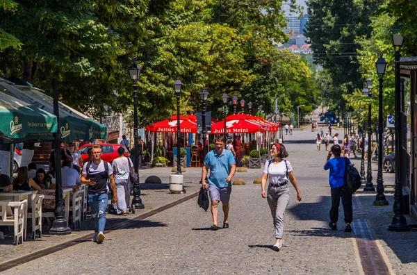Visitors walking through streets in Chișinău with local shops, cafés, and pedestrian activity