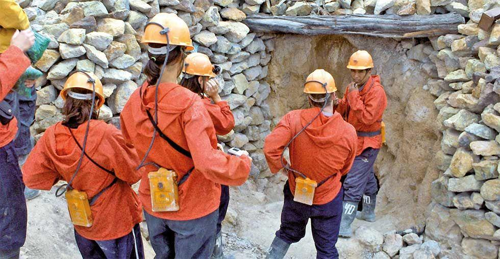 Visitors exploring the Cerro Rico mine in Potosí, Bolivia, a historic silver mining landmark.