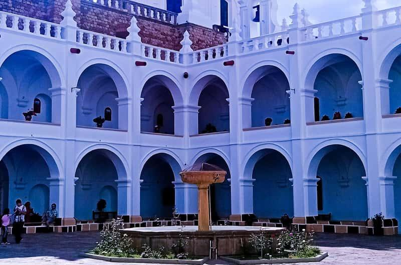 Visitors exploring the House of Freedom in Sucre, Bolivia, a historic building and cultural landmark.