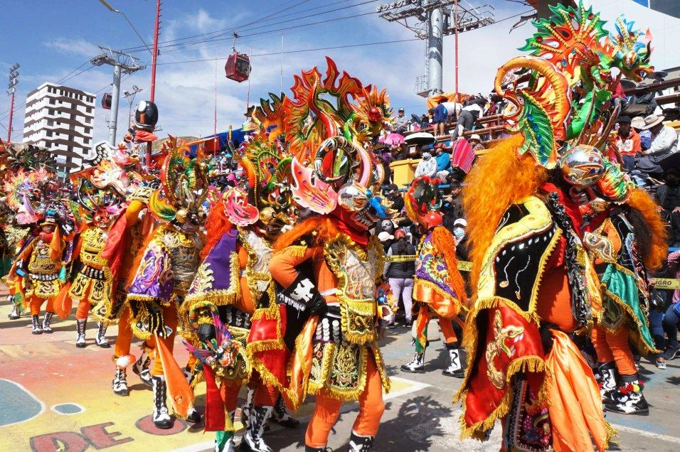 Visitors enjoying the Oruro Carnival in Bolivia, with traditional costumes and cultural performances