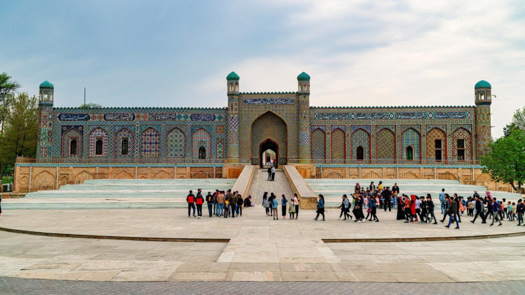 Visitors exploring the Palace of Khudayar Khan in Kokand, Uzbekistan, a historic landmark and museum.