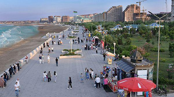 Visitors enjoying the Caspian Sea promenade in Sumqayit, Azerbaijan, a coastal landmark and recreational area.