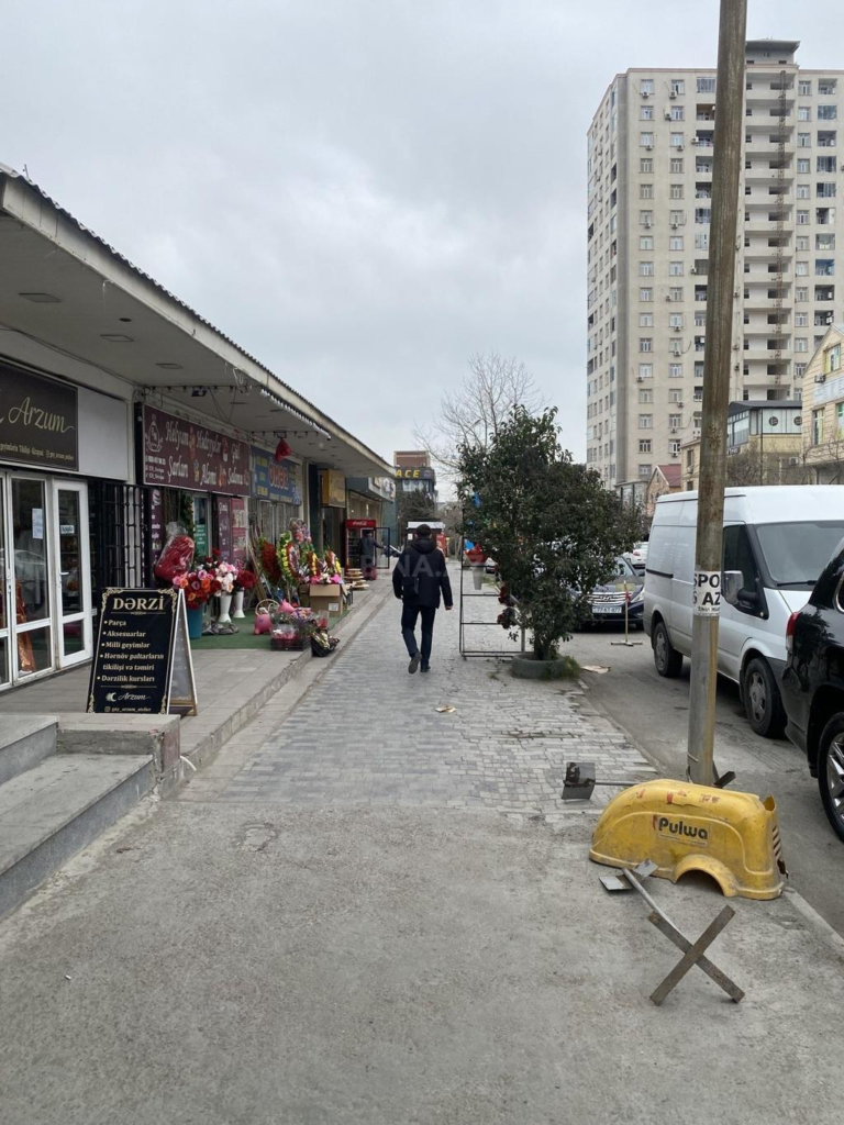 Visitors walking through streets in Khirdalan with local shops, cafés, and pedestrian activity