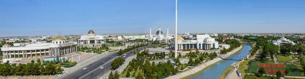 A panoramic aerial view of Mary showing the cityscape, surrounding desert, and distant mountains in Turkmenistan