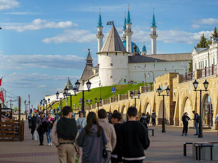 Visitors exploring the Kazan Kremlin in Kazan, Russia, a historic landmark reflecting Tatar and Russian heritage.