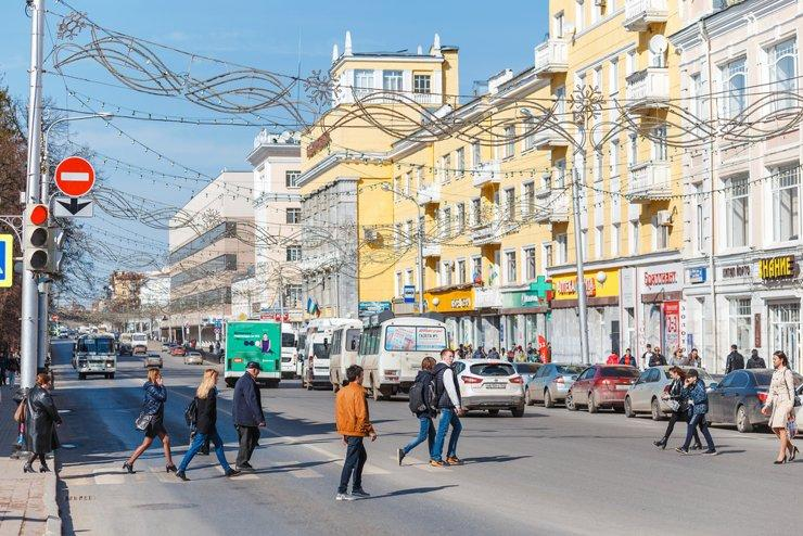 Visitors walking through streets in Ufa with local shops, cafés, and pedestrian activity.