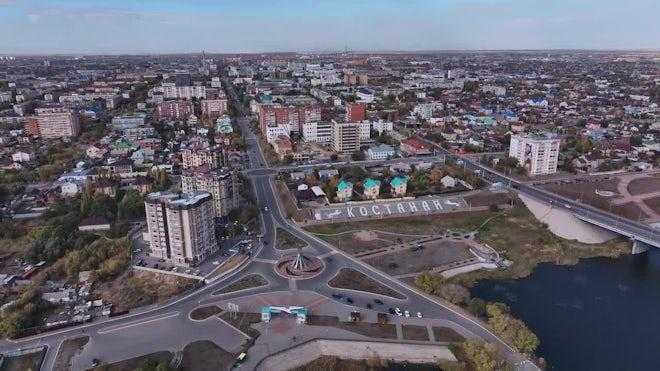 An aerial view of Kostanay showing the city skyline and surrounding urban areas.