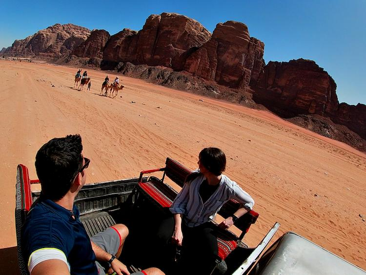 Visitors exploring the desert landscape of Wadi Rum in Jordan