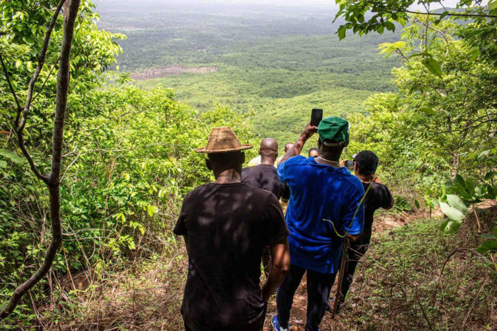 Visitors exploring a forest and wildlife area in Guinea’s nature reserve