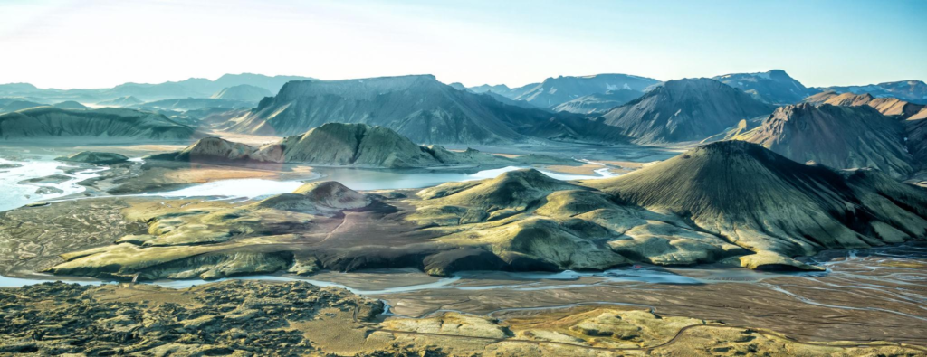 Aerial view of Iceland showing volcanic mountains, glaciers, and rugged landscapes