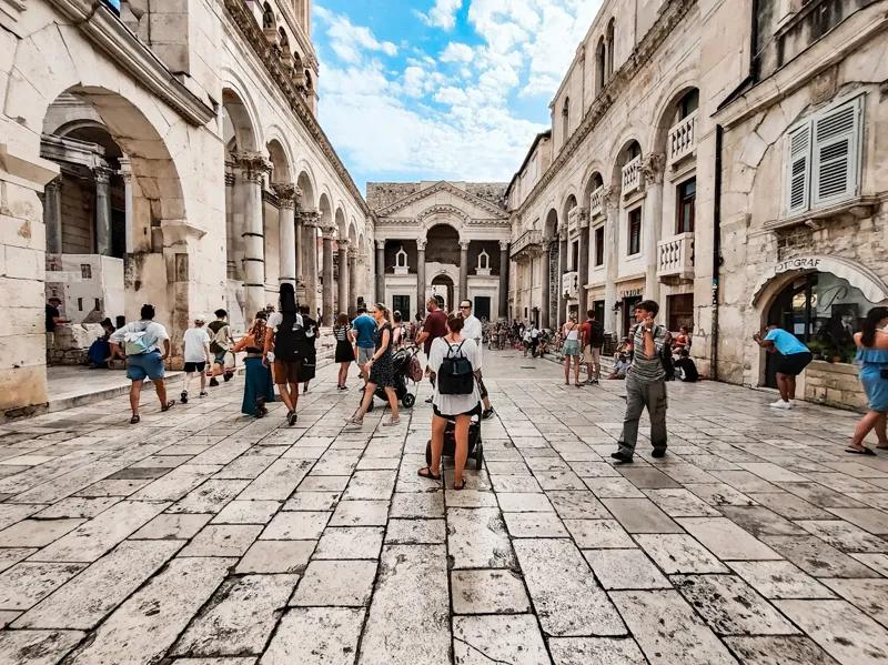 Visitors strolling through the historic streets surrounding Diocletian's Palace in Split.