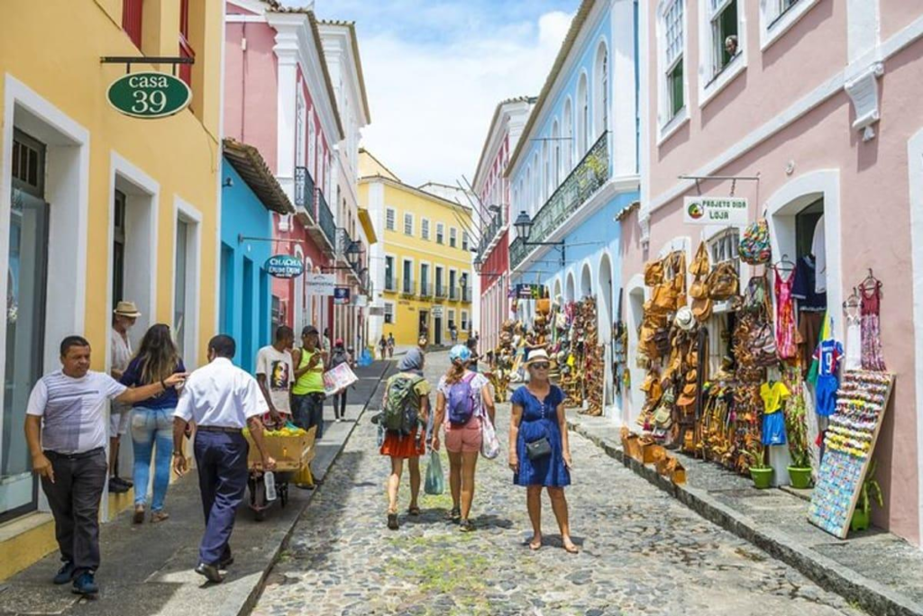 Visitors walking along colorful colonial streets in Salvador's historic Pelourinho district.