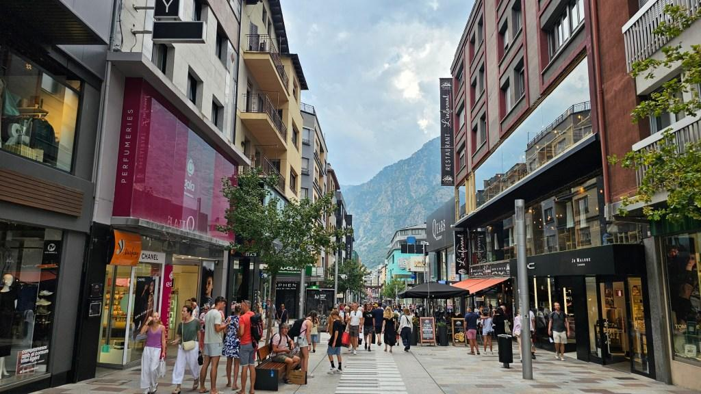 Visitors walking through the stone streets of Andorra la Vella's historic old town.