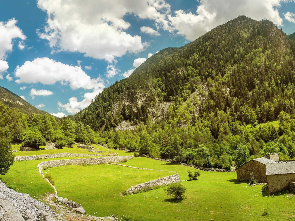 A mountain hiking trail winding through the Madriu-Perafita-Claror Valley surrounded by alpine scenery.