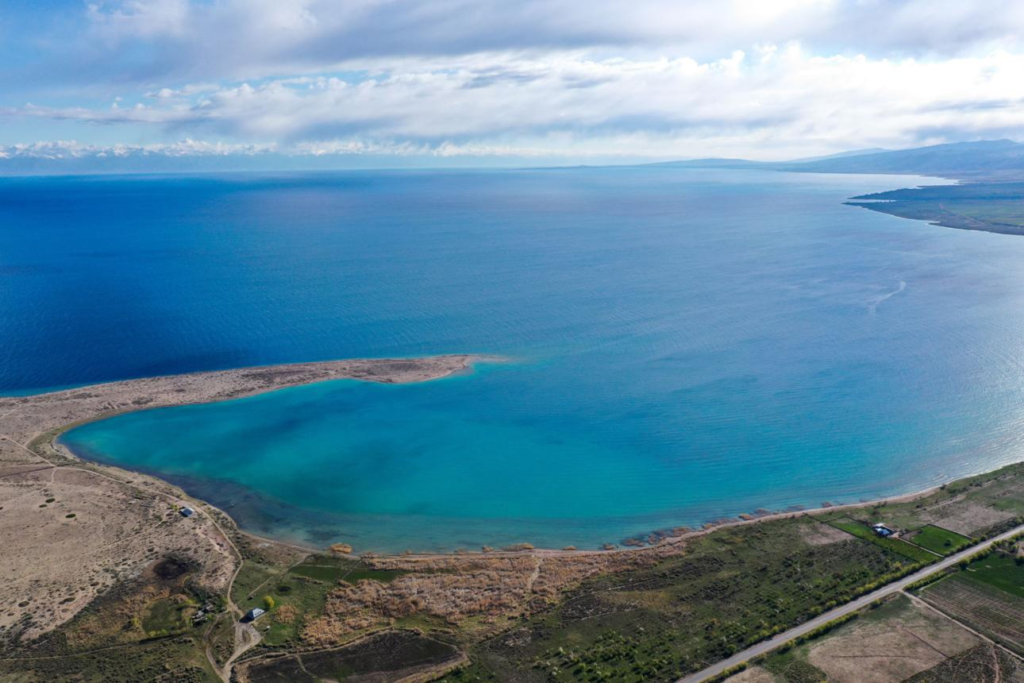 Crystal-clear waters bordered by dramatic mountain scenery, beaches, and resorts